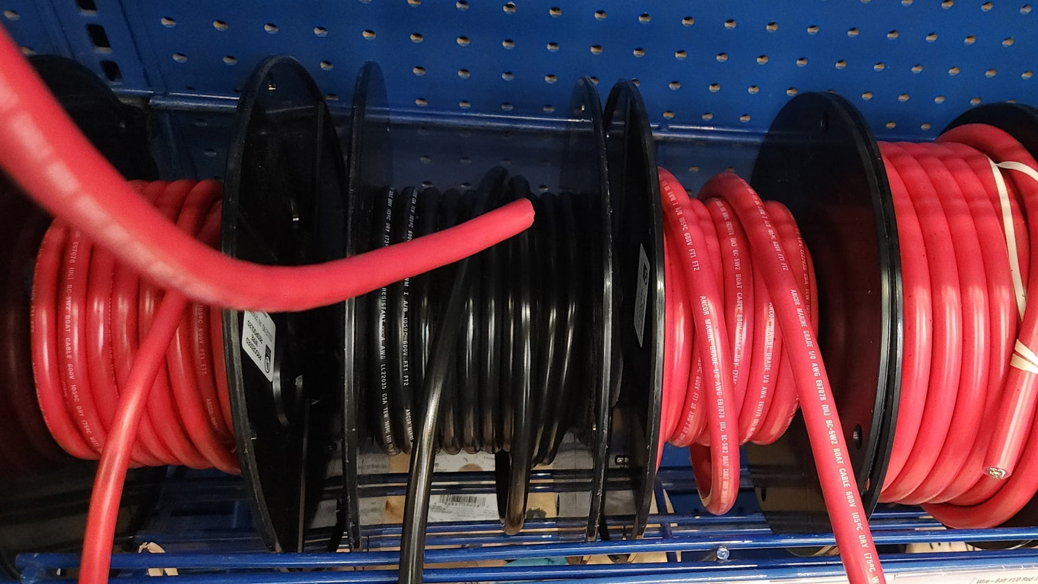 Marine electrical cables on spools, essential for boat repairs.