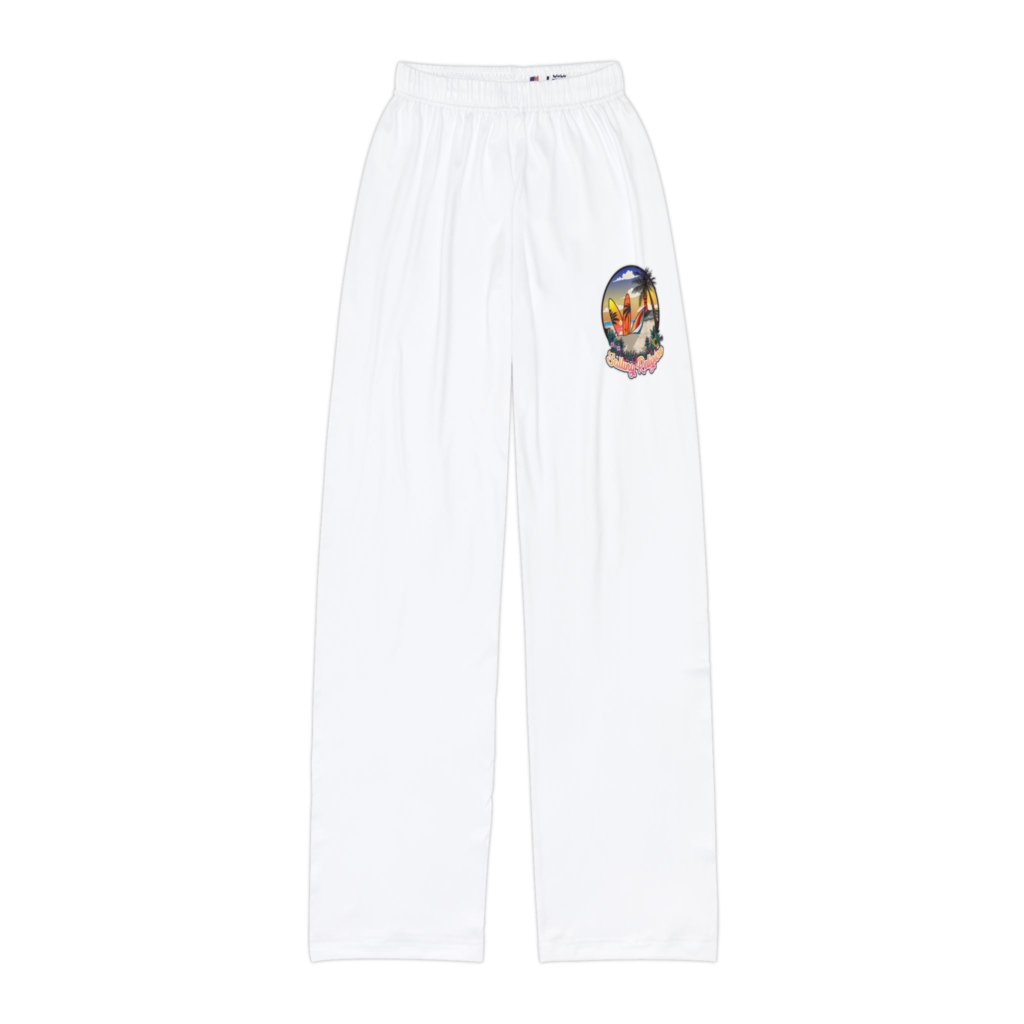 White kids pants with elastic waistband featuring a colorful tropical surf print on the upper left leg, including palm trees, surfboards, and the Sailing Religion logo.